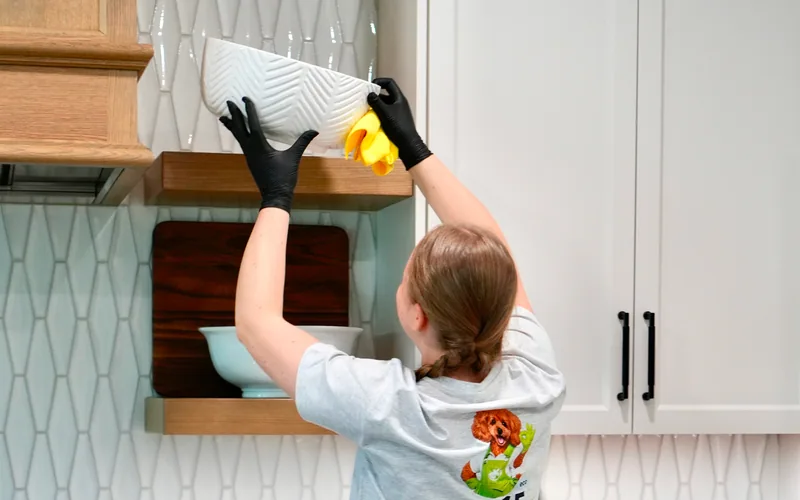 EDGE Cleaning specialist carefully cleaning a kitchen range hood